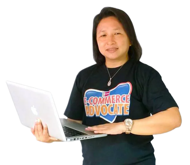 Janette Toral holding a laptop, wearing an E-Commerce Advocate shirt